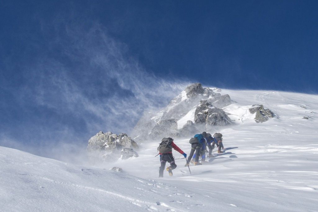 team of mountain climbers in snow