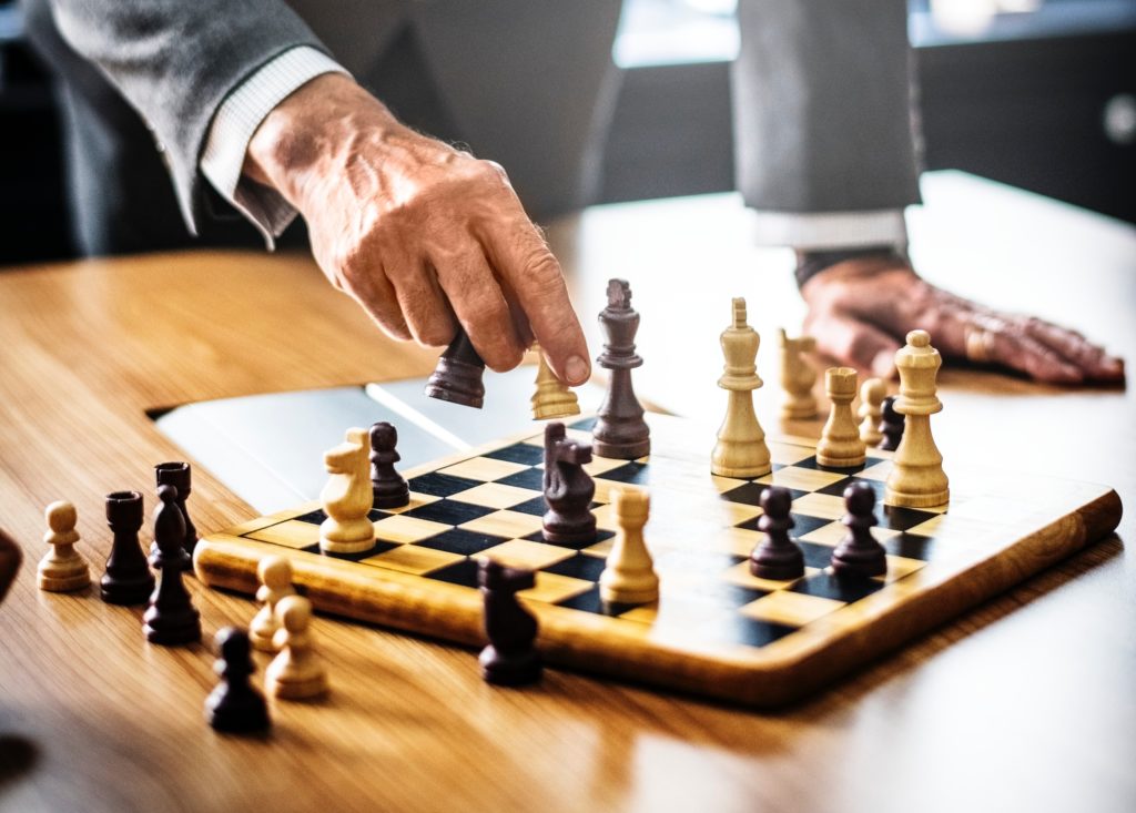 Man standing and playing chess