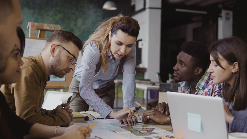 Woman leader with team working on strategic plan