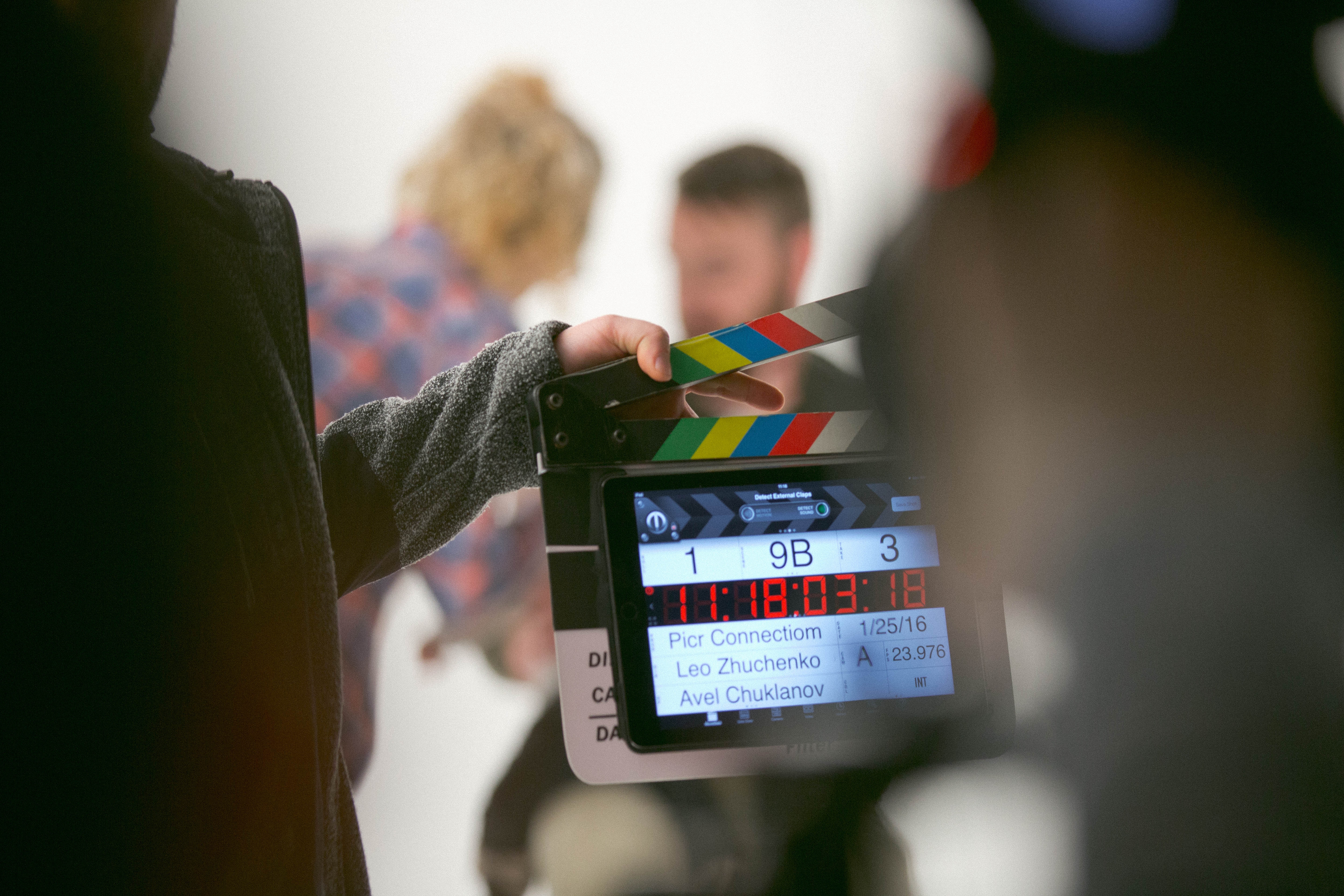 Camera crew and man preparing for television appearance