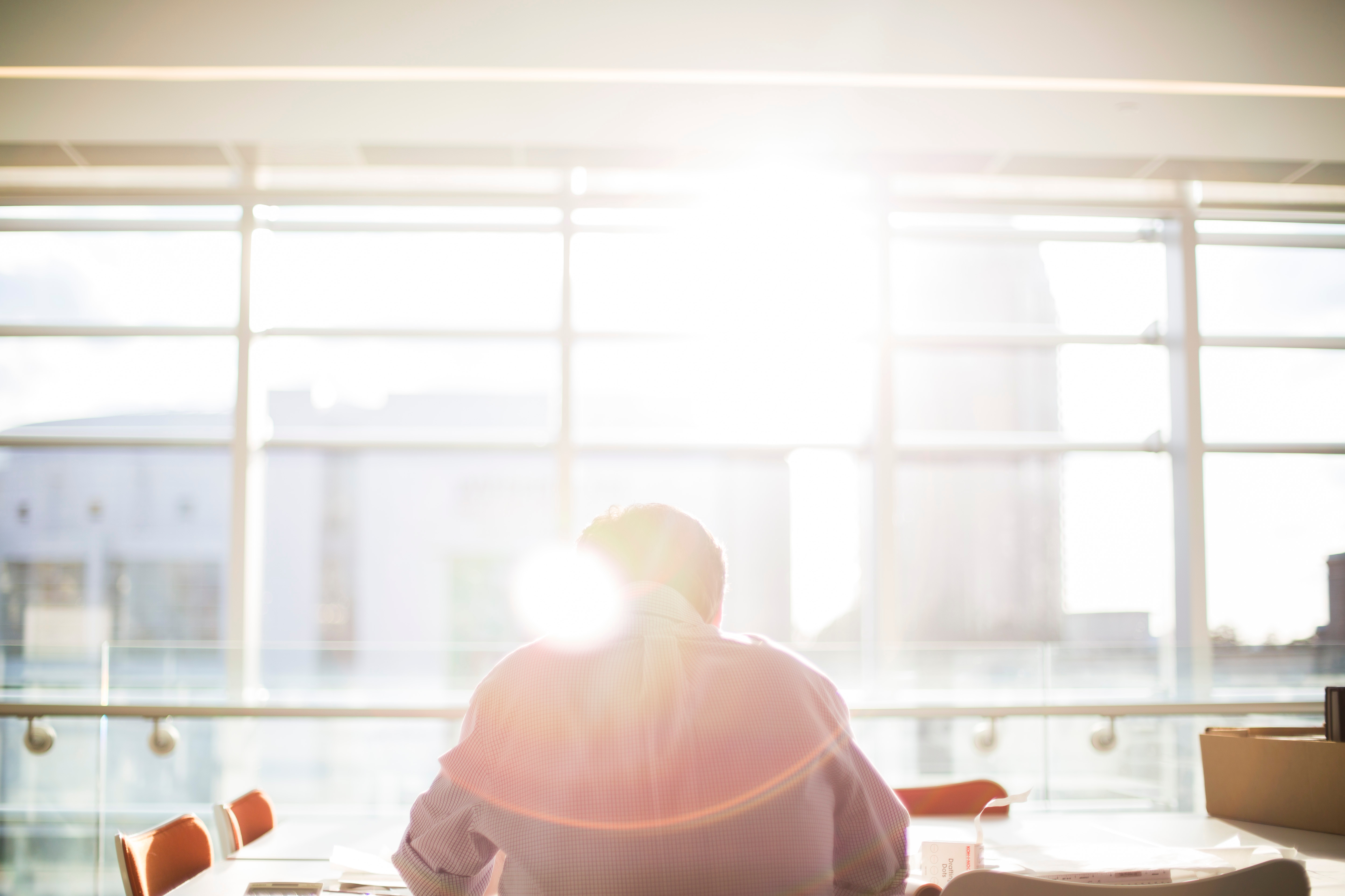 Man sitting in conference room on top level of office building