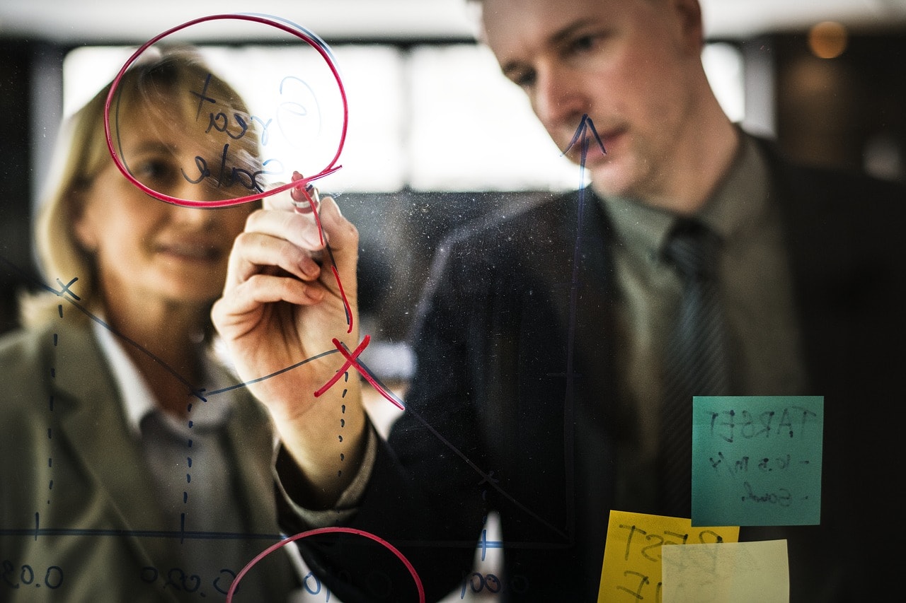 Man and woman colleagues drawing plan