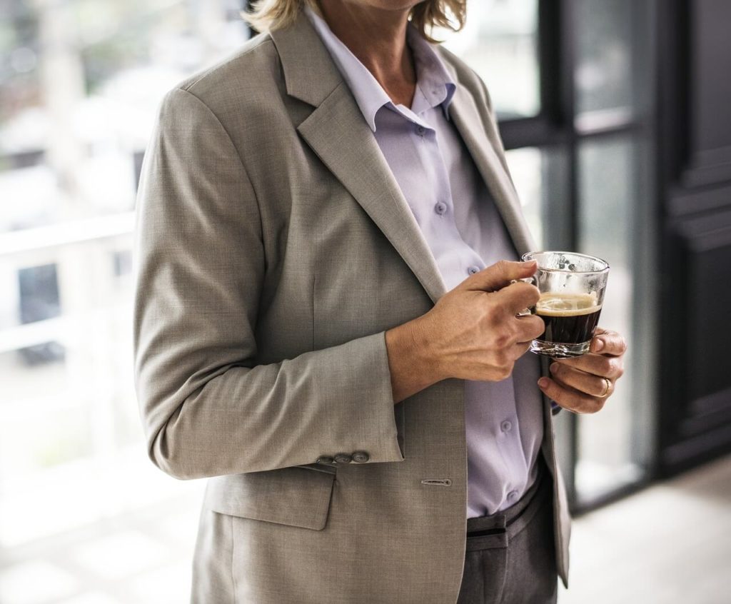 Woman business leader drinking coffee in cafe