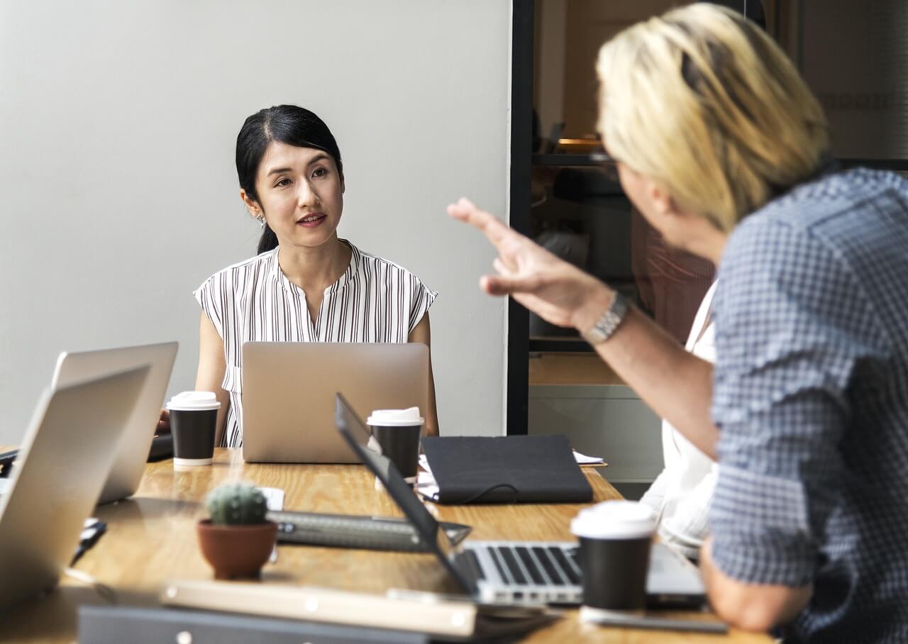 Woman leader answering question in meeting