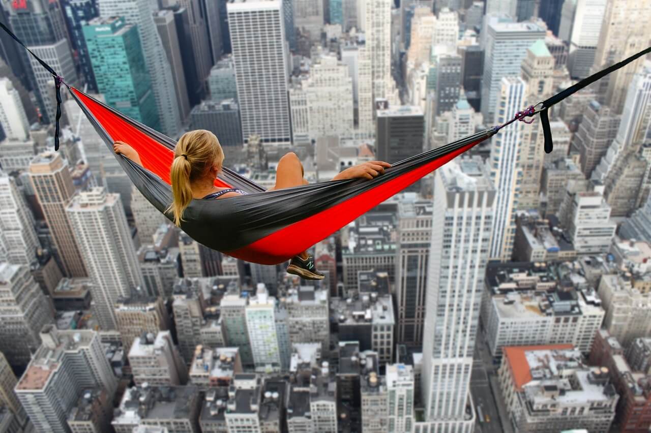 Woman swinging in hammock above Hong Kong