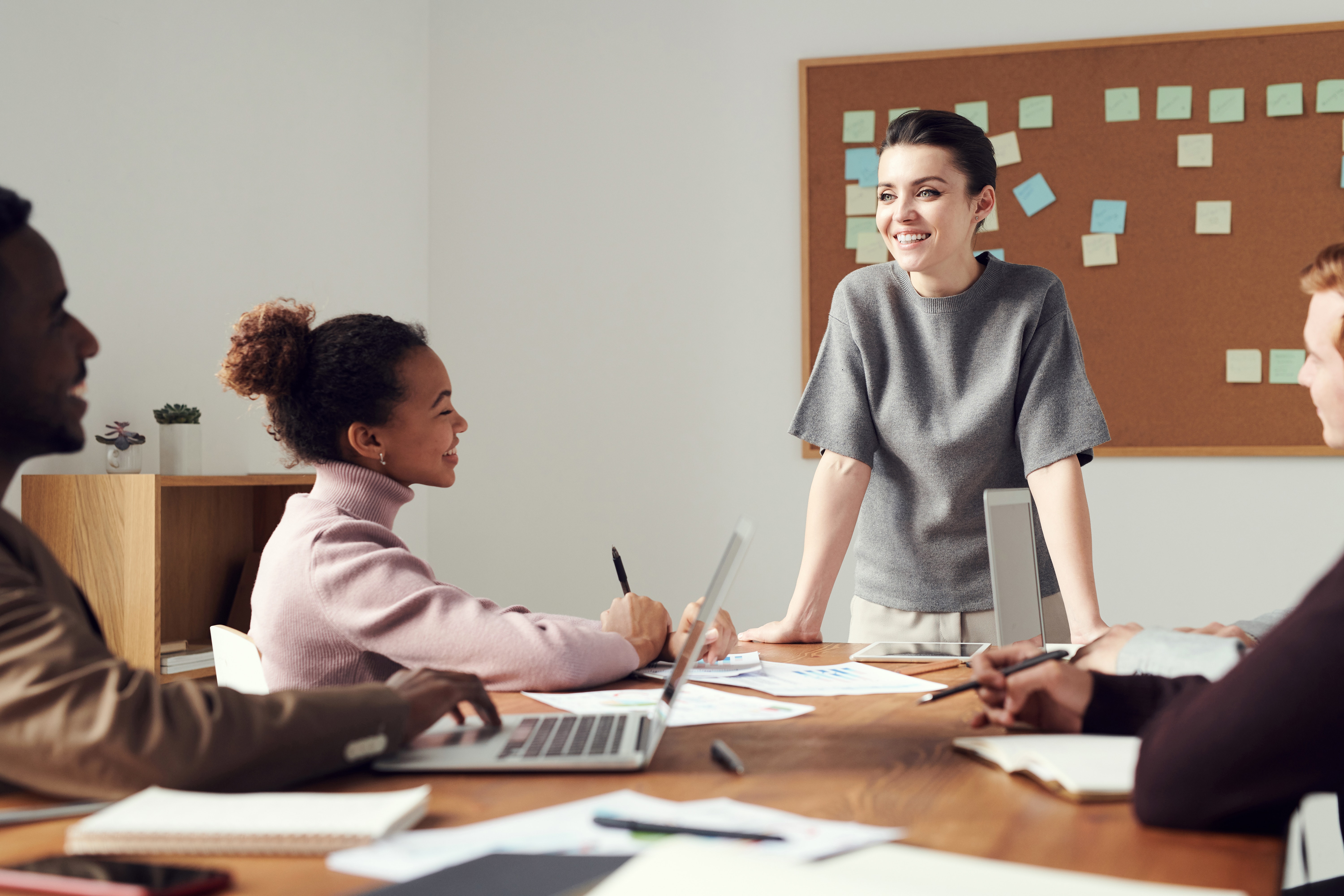 boss speaking to team at conference table