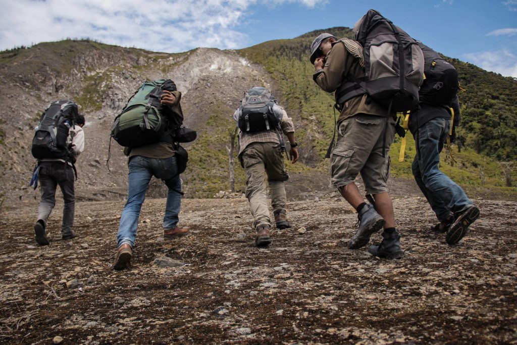 People hiking up tall mountains.