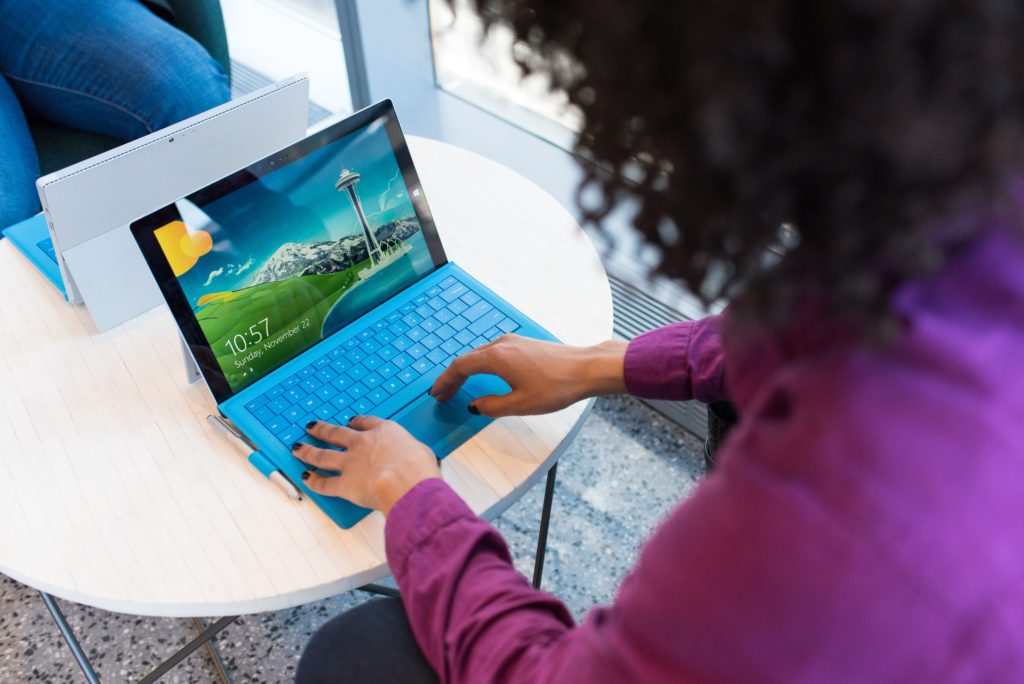 Women in IT working at laptop.