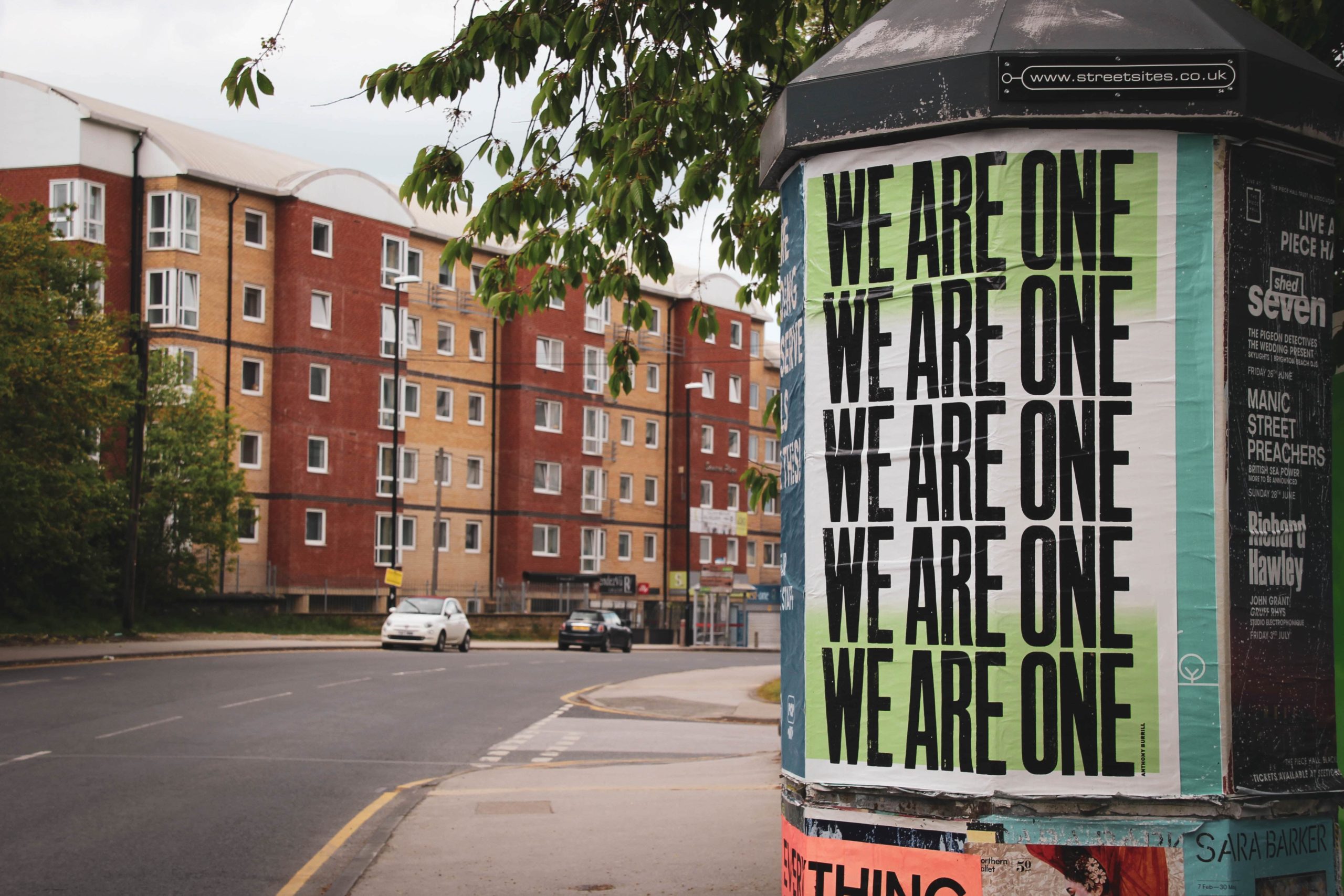 lampost sign that reads we are one