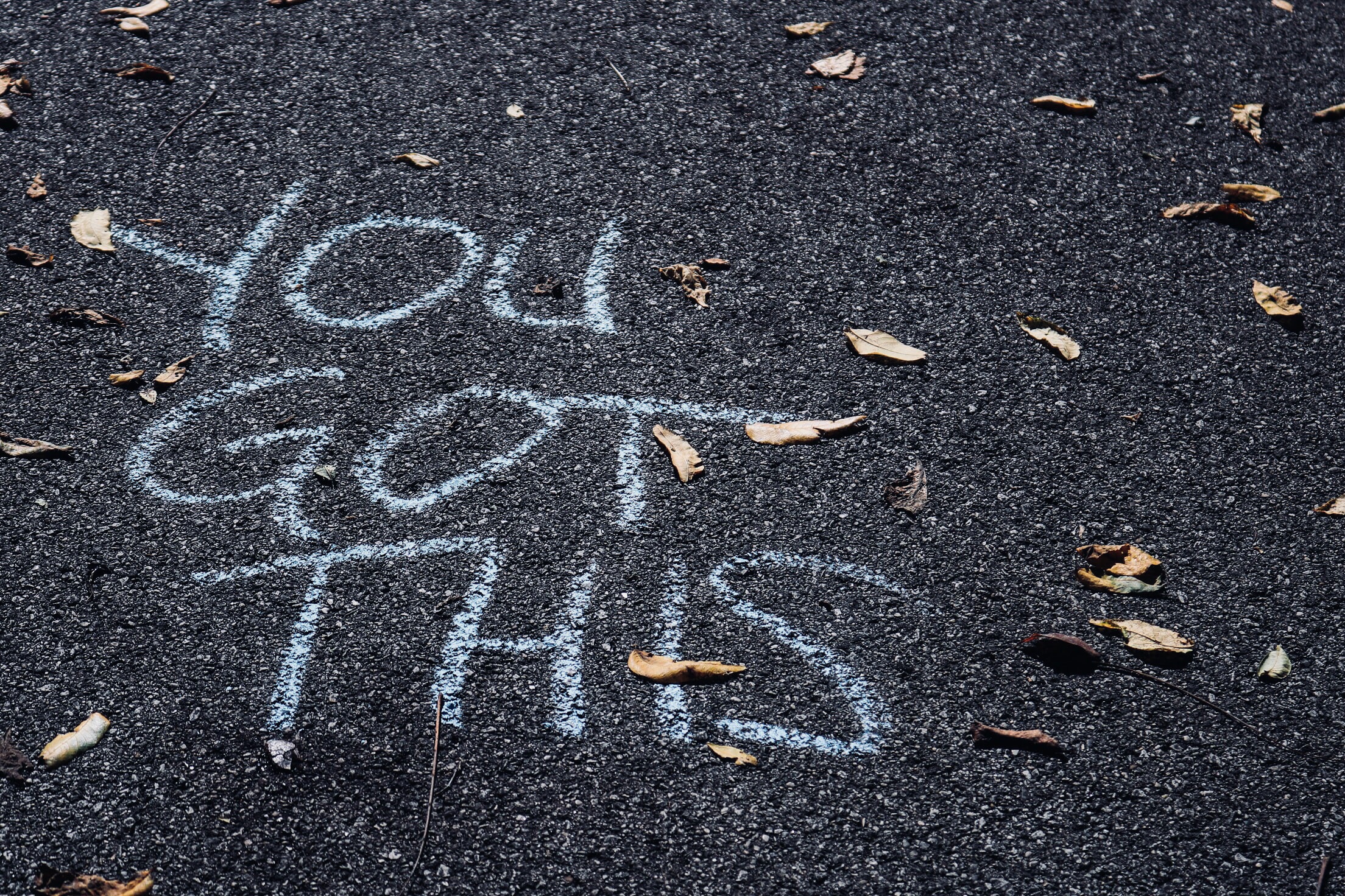 The words you got this written in chalk on street asphalt