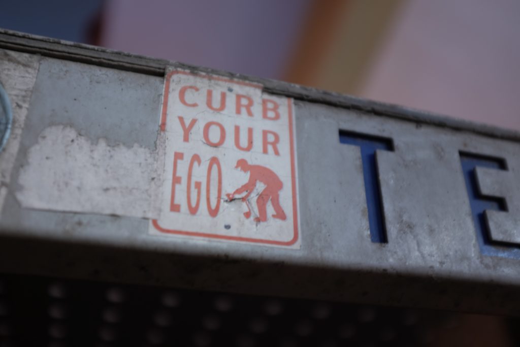 curb your ego sign