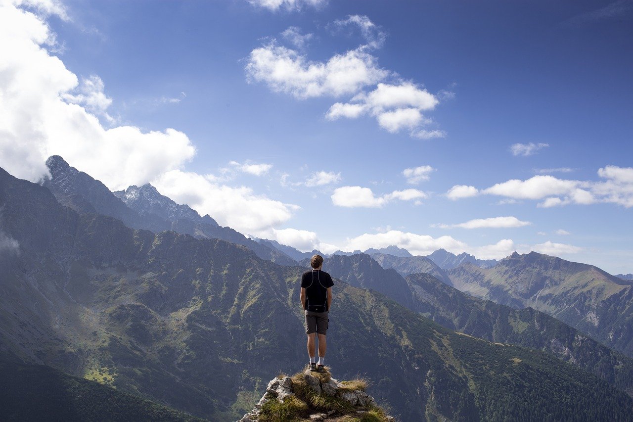 man on top of mountain