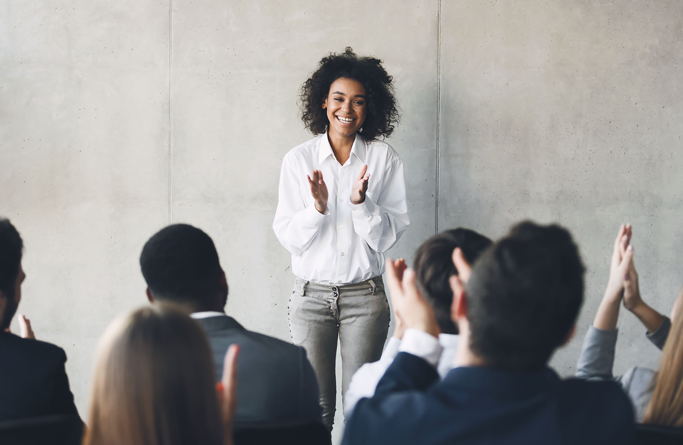 woman standing in front of crowd with courage