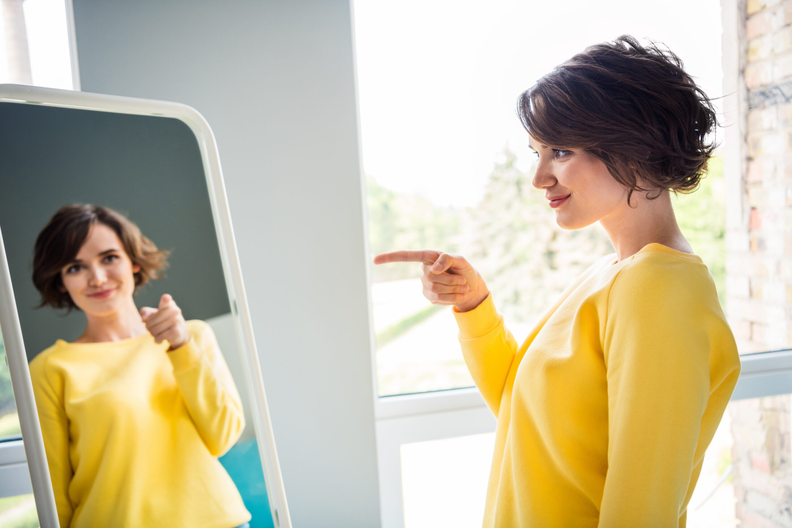 women looking confidently in the mirror